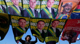 A street vendor sells campaign flags of presidential candidates Sen. Flavio Bolsonaro and current President Luiz Inacio Lula da Silva who is running for reelection in Brasilia, Brazil, Tuesday, Sept. 29, 2026. 