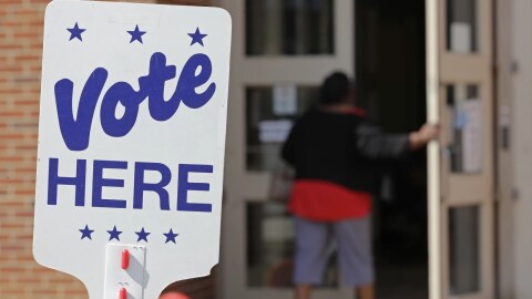 A voter enters an indoor polling place.