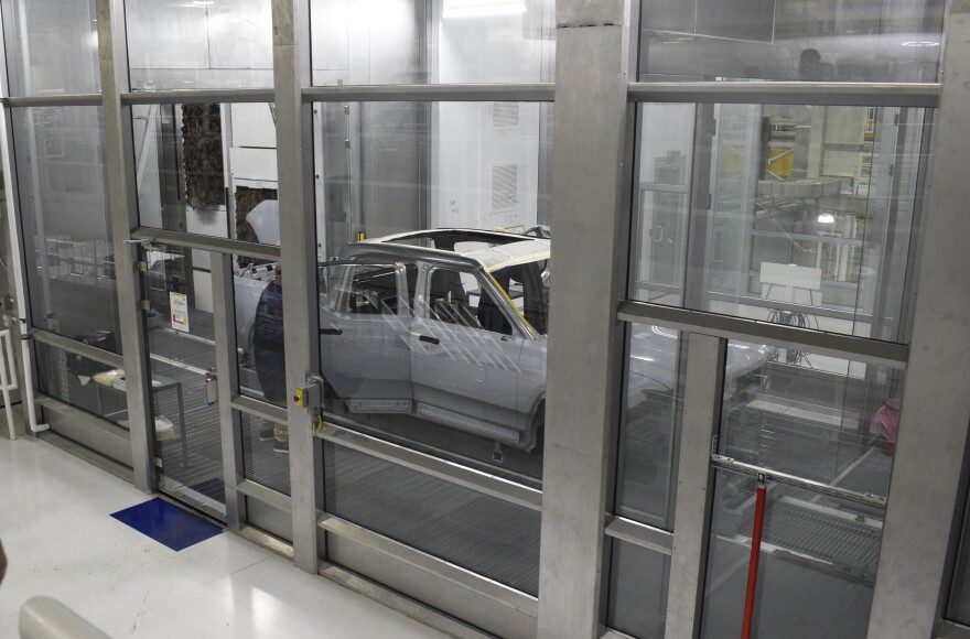 A Rivian R1T electric pickup moves through the Paint Shop on Tuesday, April 12, 2022, in Normal.