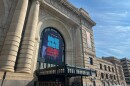 The facade of the art deco Union Station features a blue banner that says "We Are 26" in light blue and red lettering.