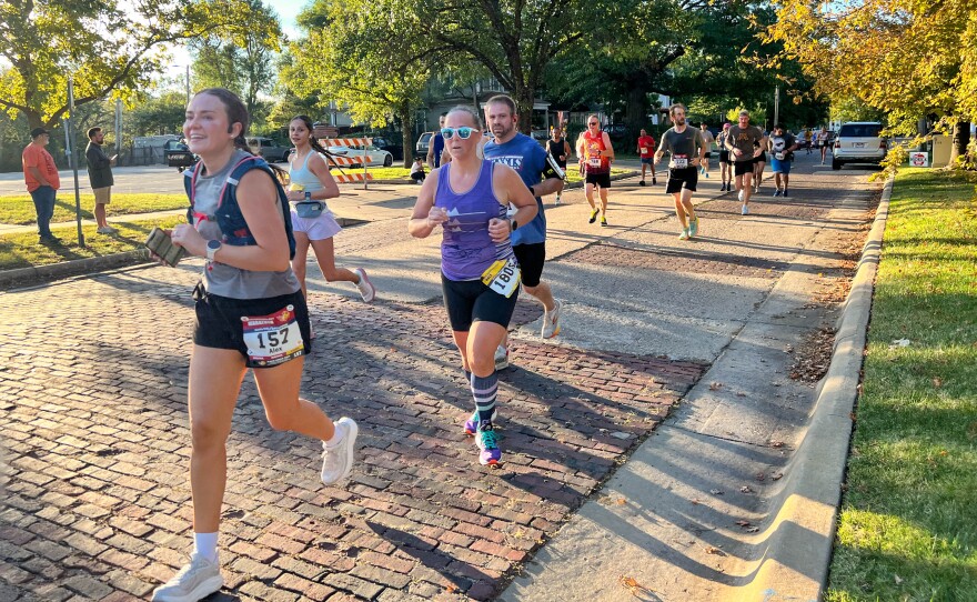 Family and friends find spots along the route to park their cars and cheer on runners near the College Hill Park.