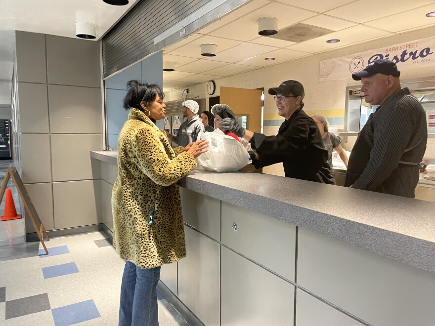 FWCS Career Academy students and staff hand out a meal to a community member who came in during the Give Back Thanksgiving event on Monday, November 21, 2022.