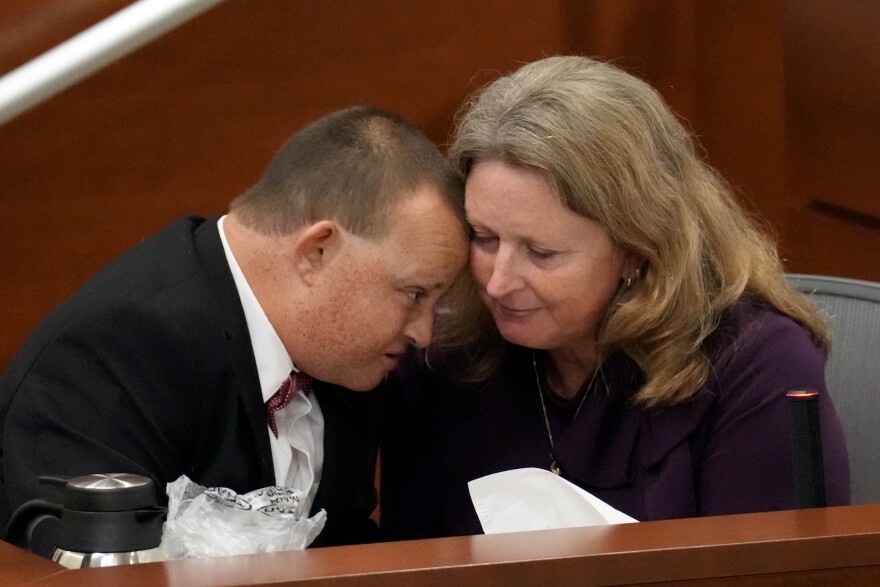 Corey Hixon leans in close to his mother, Debbie Hixon, while giving his victim impact statement during the penalty phase of the trial of Marjory Stoneman Douglas High School shooter. (Amy Beth Bennett/South Florida Sun Sentinel via AP, Pool)