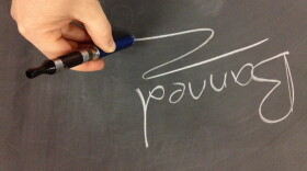 The image of an electronic cigarette spelling out the word "BANNED" on a chalkboard. 