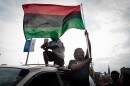 A demonstrator waves a flag from a minivan during protests Sunday evening over the acquittal of former St. Louis cop Jason Stockey. A third day of protests started peacefully before a smaller group smashed windows downtown.