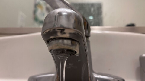 Water flows from a faucet.