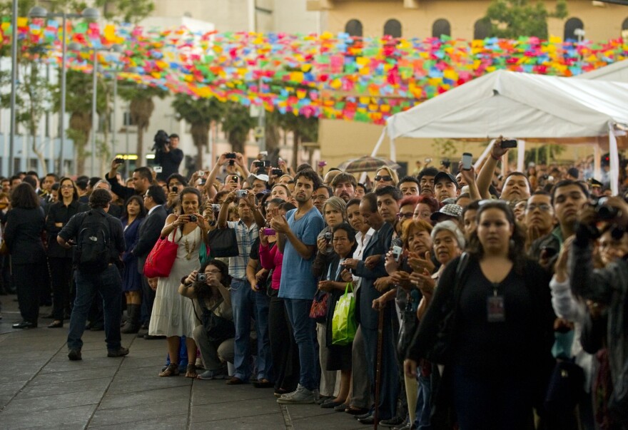 Fans wait to see the coffin of late Costa Rican-born Mexican singer Chavela Vargas during a ceremony in her honour at Garibaldi Square in Mexico City on Monday.