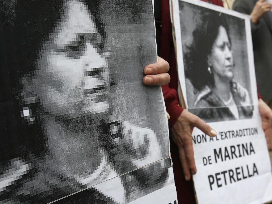 In 2008, people hold portraits of a former member of Italy's disbanded Red Brigades group Marina Petrella as they take part in a rally in Paris against her extradition to Italy. Petrella is one of seven individuals whose arrest in France was announced Wednesday.