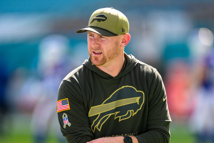 FILE - Joe Brady stands on the field before an NFL football game against the Miami Dolphins, Nov. 9, 2025, in Miami Gardens, Fla. (AP Photo/Doug Murray, File)