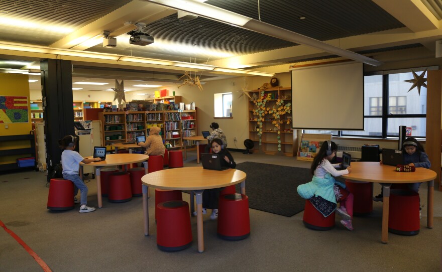 Elementary students practice reading with Amira Learning in the library at Tenderloin Community Elementary School. 