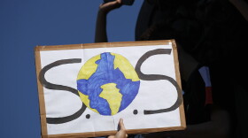 A protester shows a placard during a climate demonstration Friday, Sept. 20, 2019 in Paris. In Canberra and Kabul, Cape Town and Berlin, and across the globe, hundreds of thousands of people took the streets Friday to demand that leaders tackle climate change in the run-up to a U.N. summit. (Francois Mori/AP)