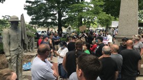 File photo: Protesters stand near a statue of Confederate and Union Civil War soldiers with a Black child kneeling between them in Allendale Township in June 2020.
