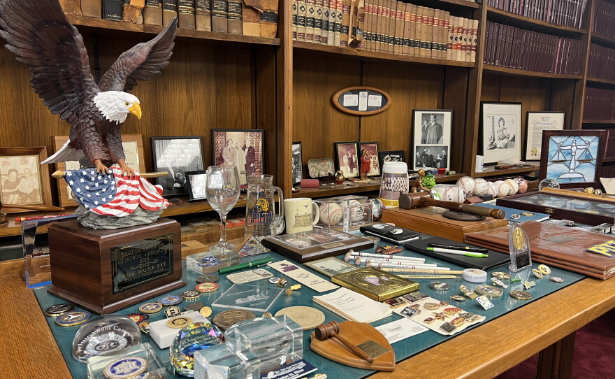 A table is filled with a number of pieces from U.S. District Court Judge Walter Rice's career in law