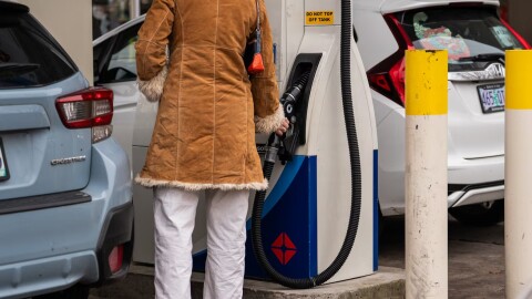 File - A person pumps gas at an Arco station on Belmont Street in Portland, Ore. on Tuesday, Nov. 25, 2025. The recently passed transportation bill would raise the gas tax by 6 cents to a total of 46 cents per gallon, and increase vehicle registration, titling fees and a payroll tax that funds public transit.