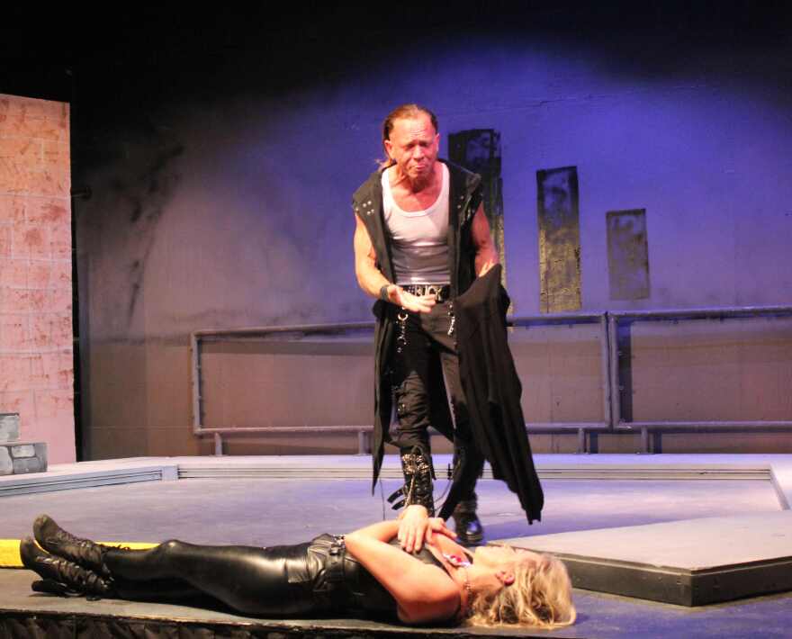 Justin Larsche as Marc Antony stands over body of Julius Caesar, played by Shelley Sanders.