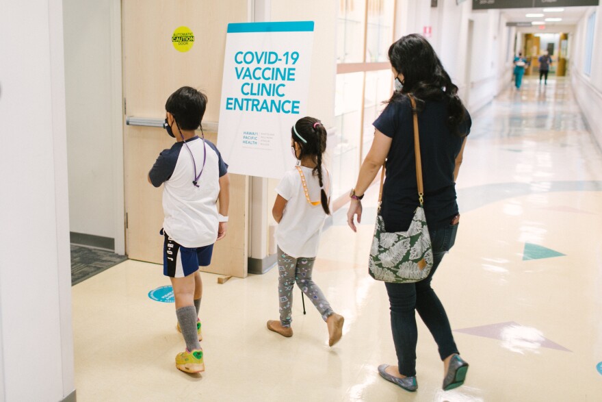 Children enter a COVID-19 vaccine clinic at Kapiʻolani Medical Center.