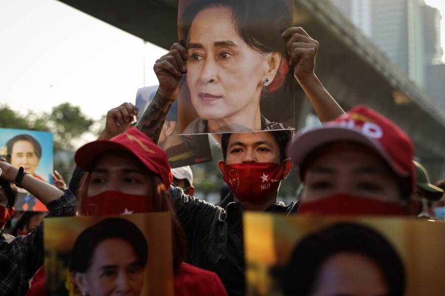 People hold up images of Myanmar's de-facto leader Aung San Suu Kyi at a protest outside Myanmar's embassy in Bangkok. Myanmar's military declared a one‑year national emergency and detained the country's de‑facto leader Aung San Suu Kyi.