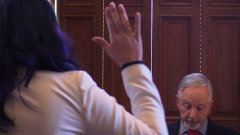 a person's hand up, an individual looking down