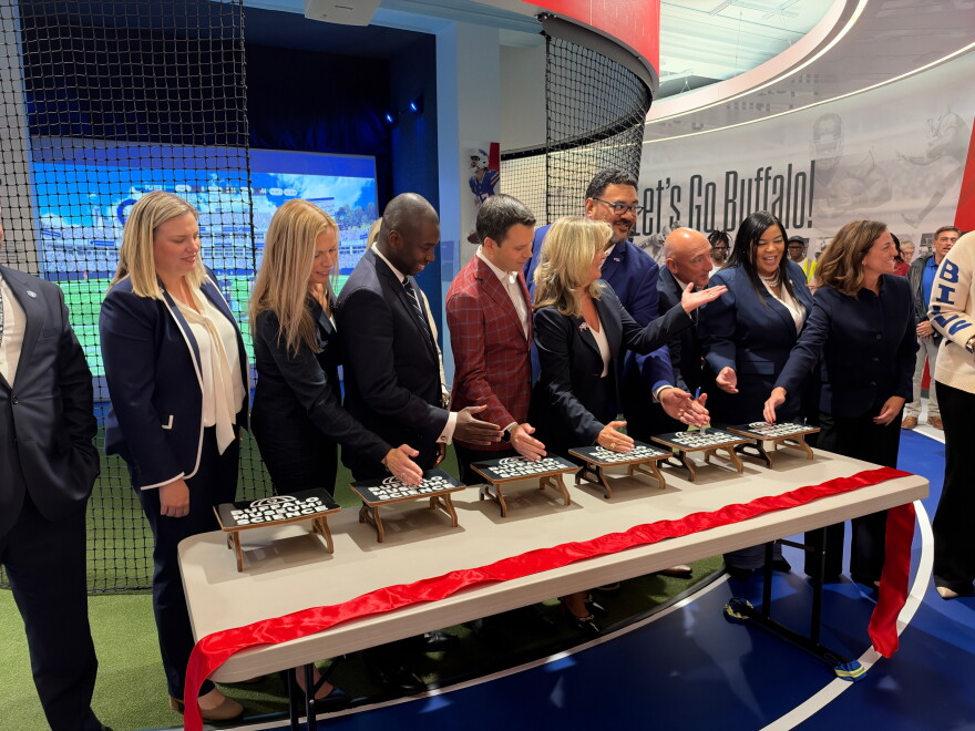 Table smashing ribbon cutting at the new sports interactive exhibit opening at the Buffalo Museum of Science
