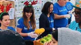 More than 400 families gather in Liberty City to receive produce and hot meals from Feeding South Florida. 