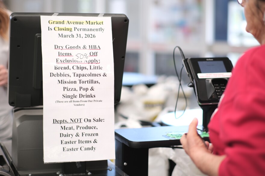 A sign telling customers what items are on sale as the store closes.