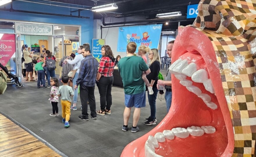 Visitors line up to pose with Daniel Tiger at Be My Neighbor Day with WKAR.