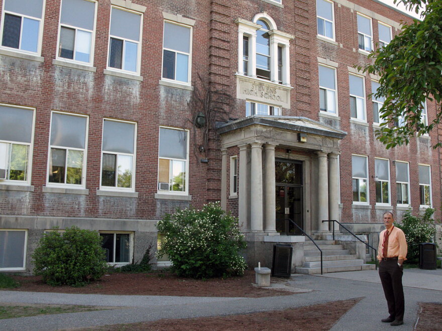 Principal Paul Couture stands in front of Stevens High School in Claremont, N.H. School officials say Stevens is at risk of losing its accreditation because the building facilities are substandard.