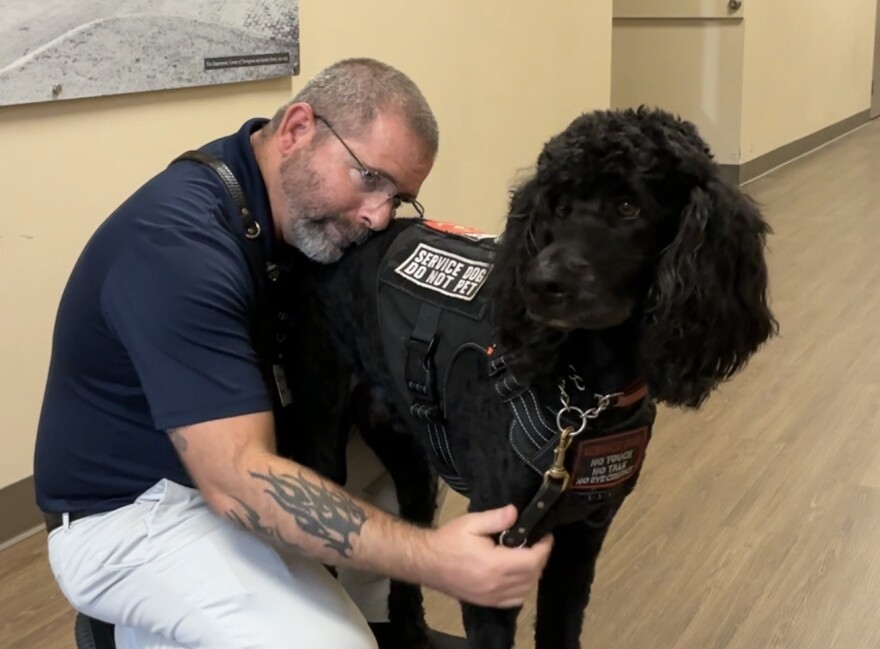 Brian Johnson rests his head on Homer during a visit at Lakeview