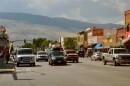 Vehicles drive on a downtown road in Cody, Wyoming