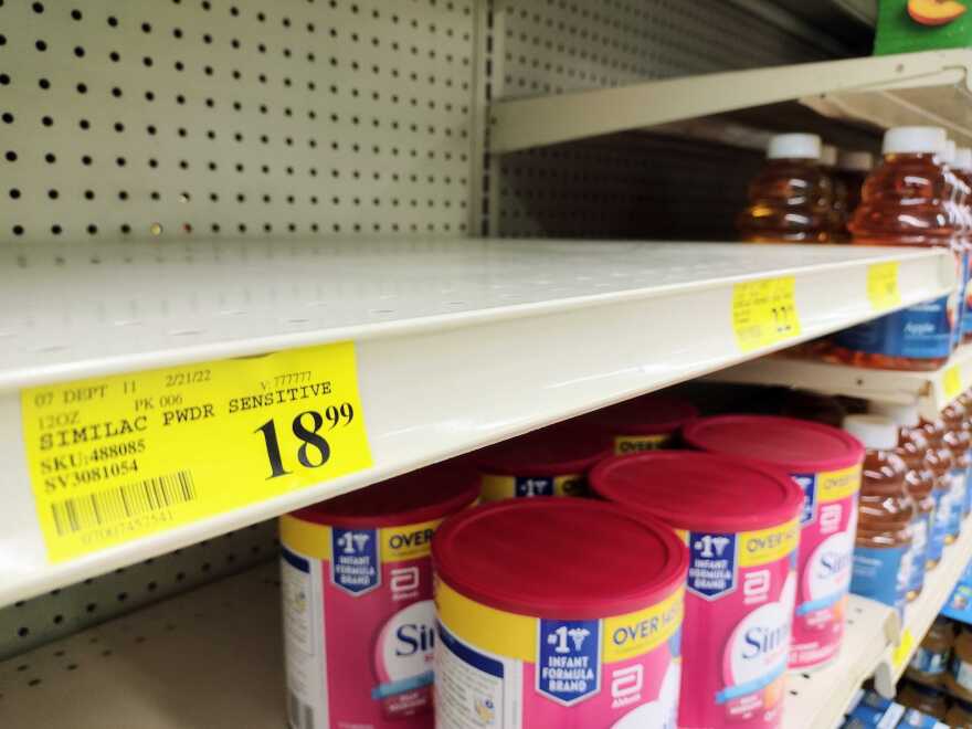 grocery store shelves partially empty of baby formula