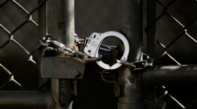 A pair of handcuffs locks together a gate at the now-shuttered Medium Security Institution on Tuesday, March 18, 2025, in north St. Louis.