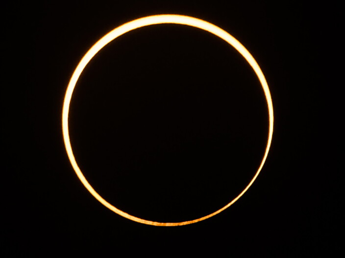 The moon moves in front of the sun in a rare "ring of fire" annular solar eclipse, as seen in the sky over Singapore on Thursday.