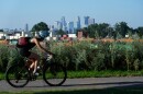 A cyclist passes the Minneapolis skyline along St. Anthony Parkway as smoke from wildfires in Canada and Northern Minnesota sets in, Wednesday, July 15, 2026. (AP Photo/Ellen Schmidt)