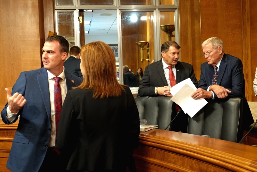 Oklahoma Gov. Kevin Stitt (left) speaks to Sen. Jim Inhofe (right) before a Senate Committee on Environment and Public Works hearing on Nov. 19, 2019.
