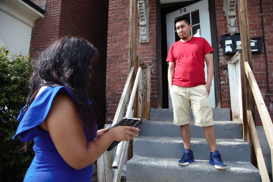 Juan Tema of Manchester talks with Hulda Suazo of the Granite State Organizing Project about the state's rental assistance program.
