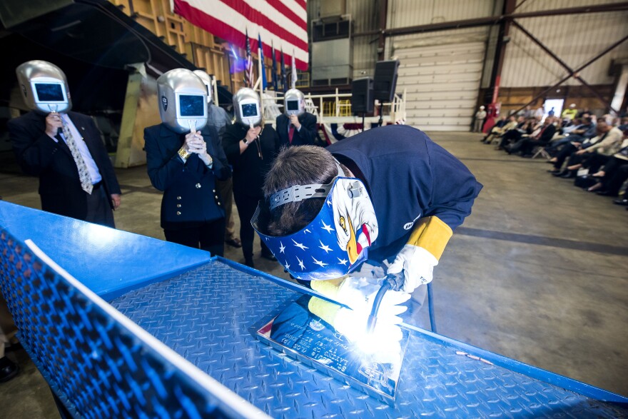 The initials of Barbara Taylor are engraved into the keep of the new USS St. Louis at a Wisconsin shipyard in 2017,