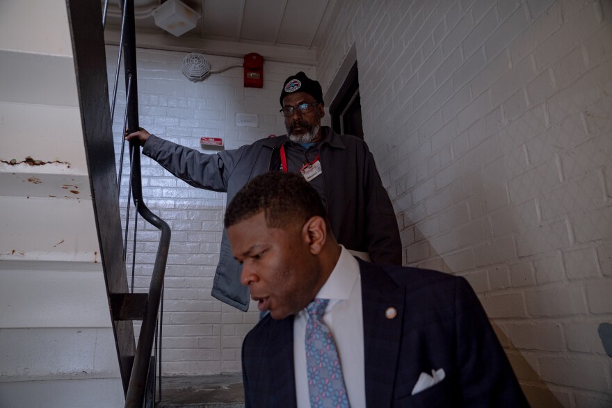 Tyrone Garrett and an employee of DCHA at Richardson Dwellings, a public housing complex in Northeast Washington.