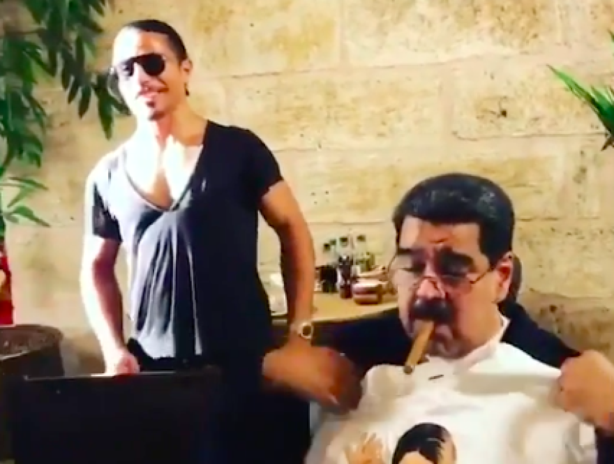 Venezuelan President Nicolas Maduro (right) receiving a T-shirt from celebrity Turkish chef Salt Bae.