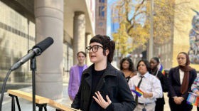 A student speaks in to a stand of microphones outside a federal courthouse in Houston on Thursday, Dec. 18, 2025.