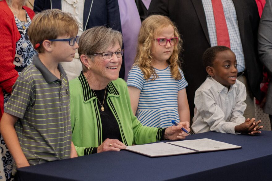 Gov. Laura Kelly signs an executive order to establish the Kansas Childhood Advisory Council following the celebration of the Kansas Early Childhood Office opening on July 1, 2026 at the Docking Building in Topeka.