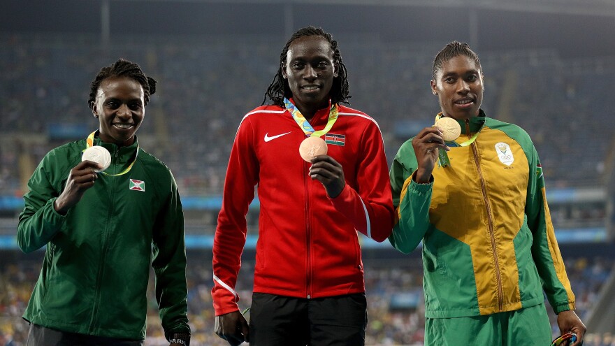 Silver medalist Francine Niyonsaba (L) of Burundi, gold medalist Caster Semenya (R) of South Africa and bronze medalist Margaret Nyairera Wambui (C) of Kenya stand on the podium during the medal ceremony for the Women's 800 meter at the Rio 2016 Olympic Games.