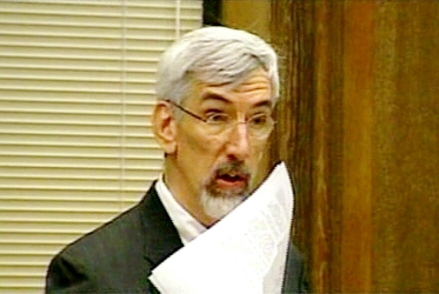 Mayor Mark Funkhouser brandishes an agreement to add 80 police officers. The police chief and council rejected it.