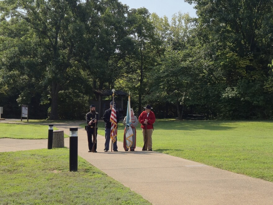A color guard representing the parties involved in the Battle of Wilson's Creek wait to bring in the flags of the United States and the US Department of the Interior.
