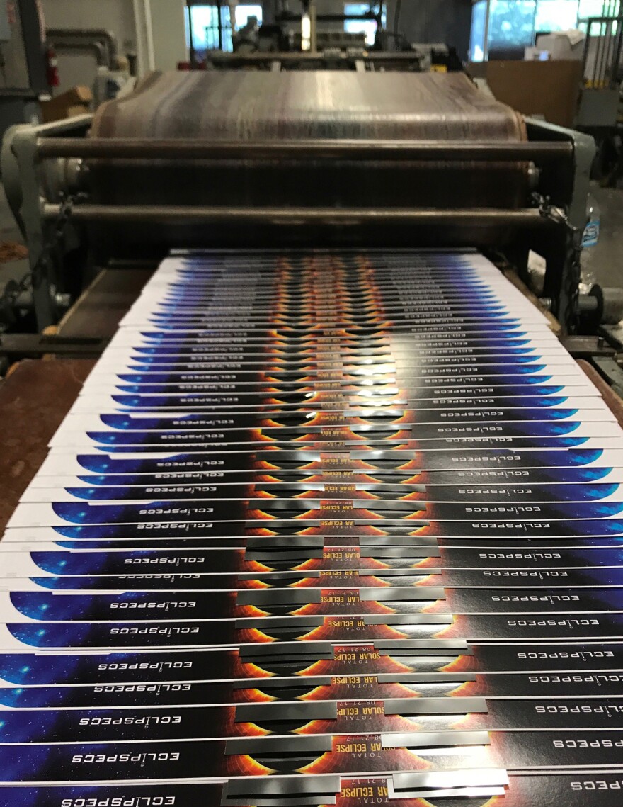 Eclipse viewers on the production line at an American Paper Optics facility. The company says it has already sold 65 million of these viewers for the upcoming total solar eclipse.