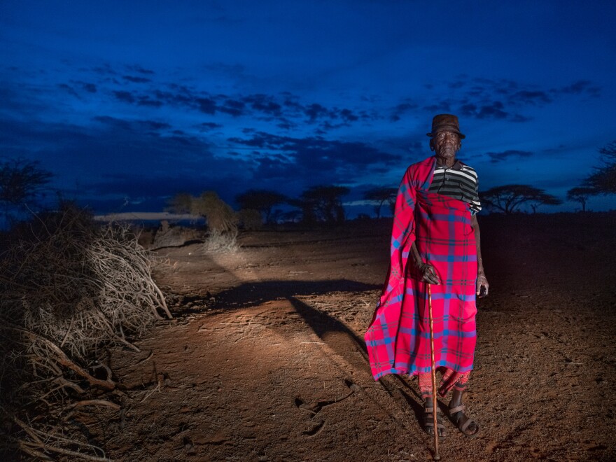 Samburu elder Francis Lengees stands near his home. In the late 1970s, he and fellow herders helped build the first structures for the primary school that Paris and his two moran "brothers" now attend.