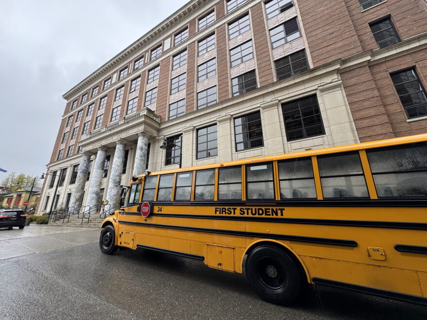 A school bus passes in front of the Alaska State Capitol on Wednesday, May 20, 2026.