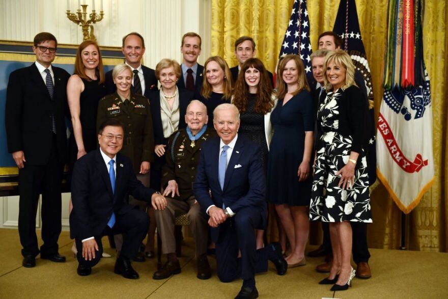 South Korea's President Moon Jae-in and President Biden pose with Col. Ralph Puckett and his family during a Medal of honor ceremony at the White House on Friday.