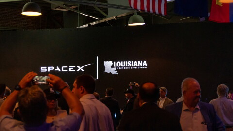 SpaceX and Louisiana Economic Development logos appear on a screen inside an event hall in downtown Abbeville, Louisiana, during the SpaceX announcement on Tuesday, August 25, 2026. 