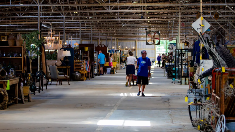 Shoppers browse furniture and vintage finds inside the Antique Tobacco Barn along Swannanoa River Road in Asheville on July 1, 2025.