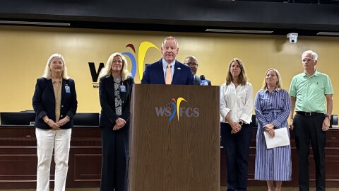 WS/FCS Superintendent Don Phipps held a press conference Monday to discuss the district's debt elimination efforts. He was surrounded by school board members and officials with All In For Our Schools.